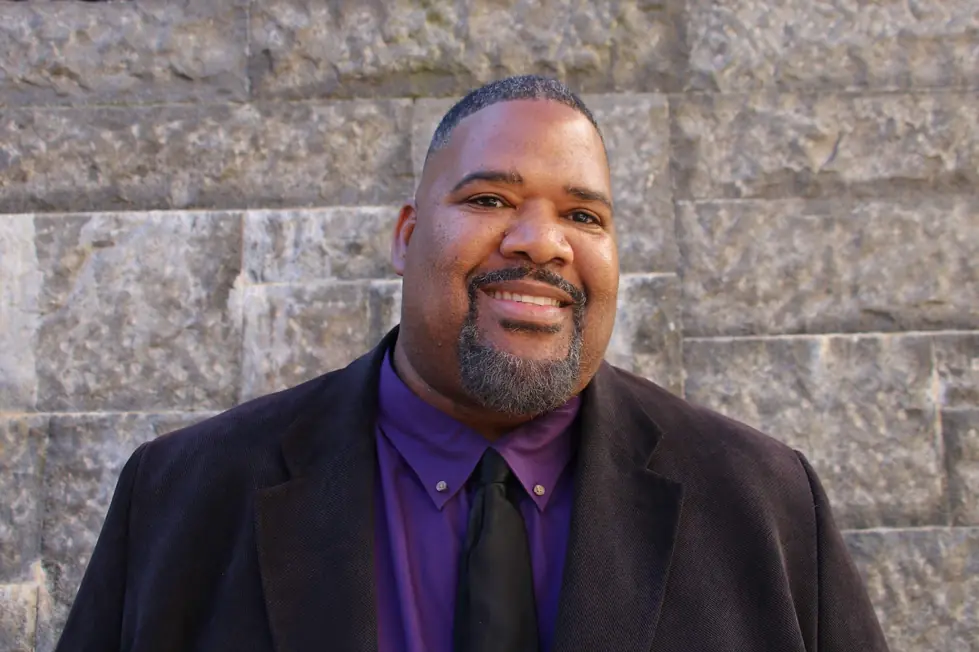 Carl Vinson, founder of Made Man Protection, in a dark blazer against a stone wall